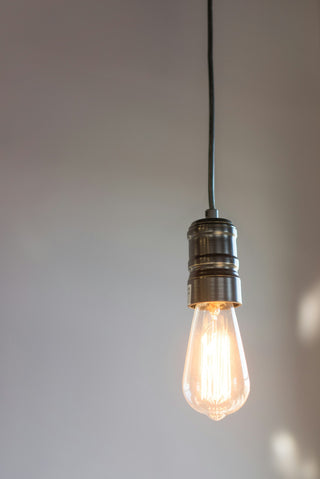 LED bulb glowing in a pendant light fixture