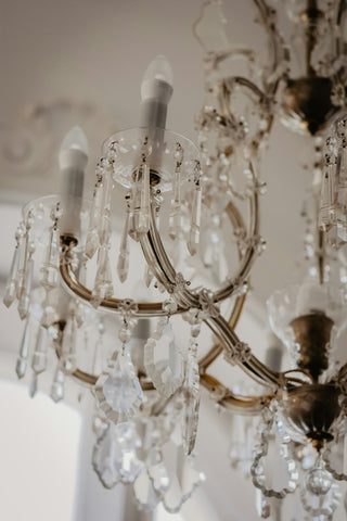 Glass chandelier lit in a room