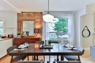 A pendant light hung at the correct height above a dining table