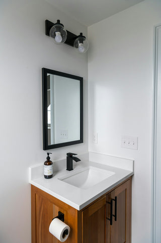 A bathroom with lighting rated for damp zones near the shower and basin