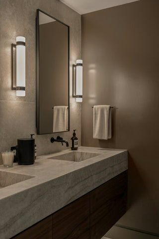 Modern bathroom vanity with wall sconces beside the mirror