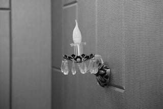 Decorative crystal wall sconce with a candle bulb