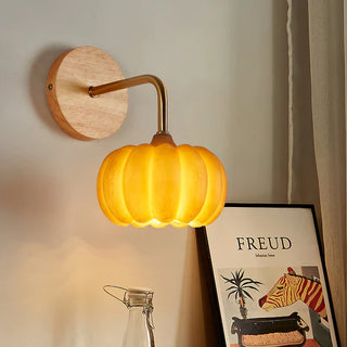 Resin pumpkin wall light illuminated — warm soft glow sconce