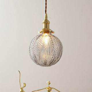 Glass globe pendant lamp detail — black and gold dining fixture