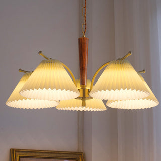 Pleated brass wood chandelier detail — elegant dining warm texture