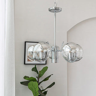 Modern silver chandelier ambient — glass metal frame warm glow