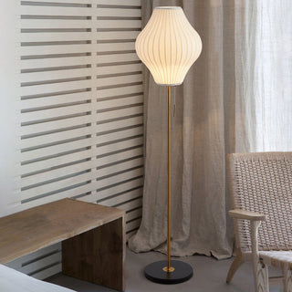 Classic white silk floor lamp illuminated — elegant warm