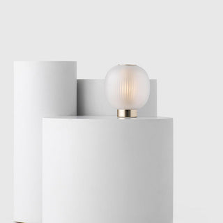 Minimalist ball table lamp in setting — warm ambient light