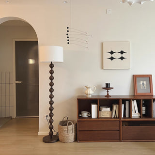 Medieval barbell lamp wide view — wood fabric warm