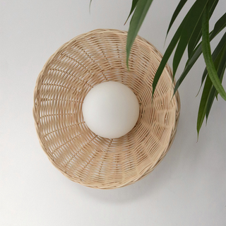 Rustic bamboo wall light rattan illuminated — glass globe
