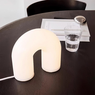 Modern arch metal lamp detail — white LED glass texture
