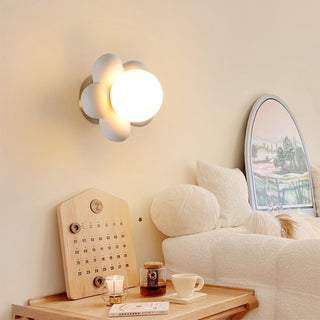 Pink ceramic flower wall lamp illuminated — floral bedside sconce