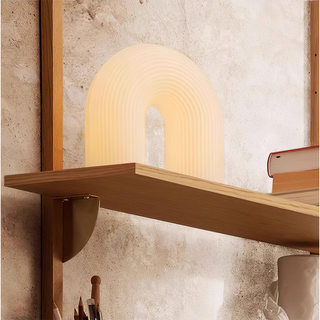 Modern arch table lamp illuminated — white metal LED warm