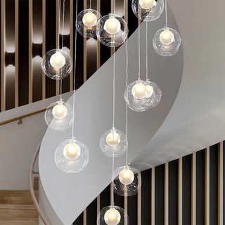 Multi-head glass globe cluster hanging in stairway interior