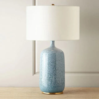 Modern ceramic lamp illuminated — fabric shade soft glow