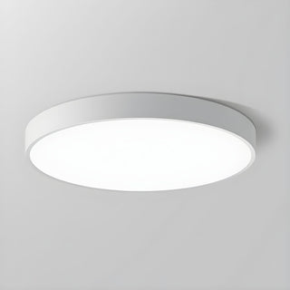 Round LED ceiling fixture illuminated, minimalist dining room