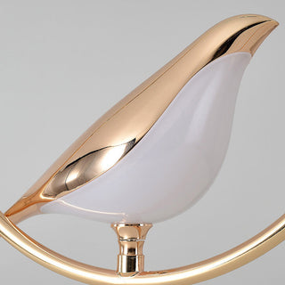 Gold bird pendant showing ornate decorative figurine