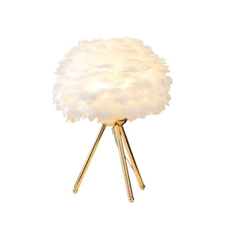 Feather tripod lamp illuminated — warm ambient glow