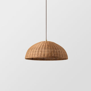Boho rattan pendant lamp casting warm dappled light