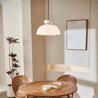 Classic glass dome pendant hanging over dining table