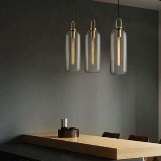 Glass pendant hanging in living room — adjustable single bulb lamp