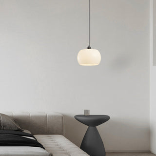 Milk white glass pendant casting soft warm diffused glow