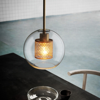 Pendant with gold-finish hardware and modern glass shade