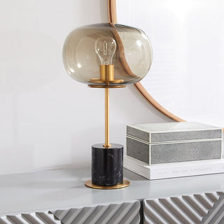 Marble sphere table lamp — golden stem glass globe close-up