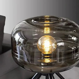 Glass table lamp tripod illuminated — warm white glow