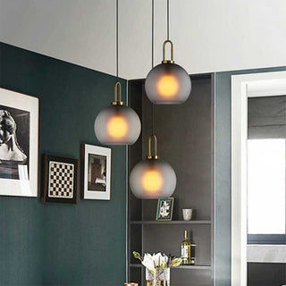 Modern glass pendant close-up — adjustable single bulb fixture