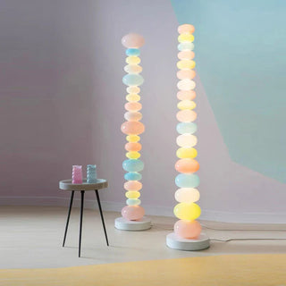 Colorful glass floor lamp illuminated — rainbow warm glow