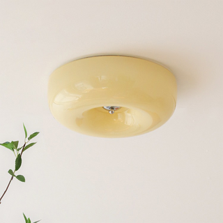 Close-up of cream glass ceiling lamp, warm LED soft ambient light
