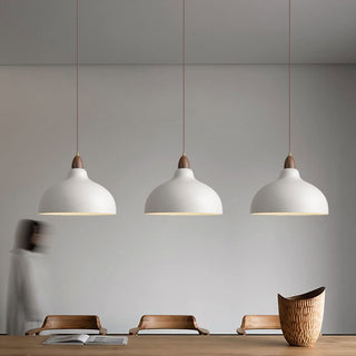 Pot-inspired pendant casting warm ambient glow in dining