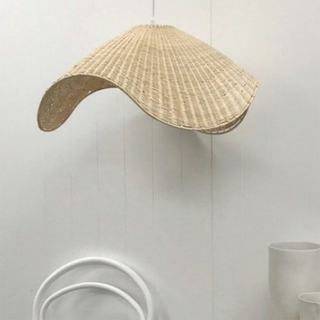Natural rattan pendant over dining table — Scandinavian style