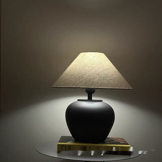 Pottery matte black lamp front — ceramic rounded design