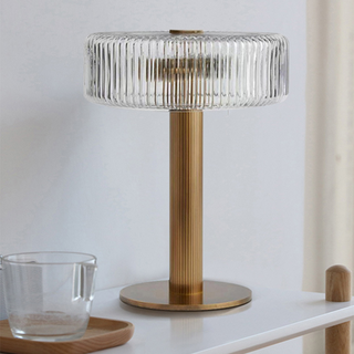 Modern gold lamp side — clear glass base warm glow