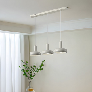 Die-cast metal pendant in soft cream finish over dining table