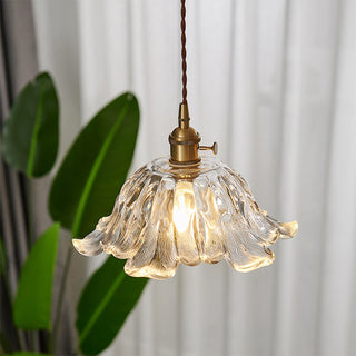 Clear glass pendant close-up — flower brass creative hanging lamp