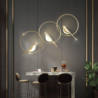 Circle pendant with decorative gold bird motif and LED