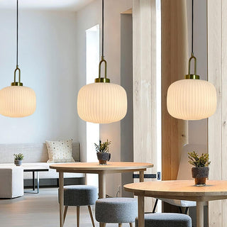 Iron-framed pumpkin glass pendant over dining table