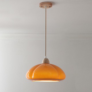 Glass pumpkin pendant hanging in vintage interior — adjustable lamp