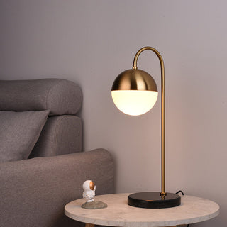 Designer sphere lamp brass arc front — radiant orb design