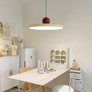 Metal pendant light casting soft warm glow — bedroom