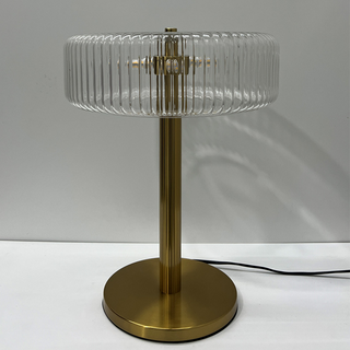 Modern gold glass lamp detail — clear base warm
