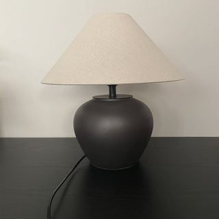 Pottery lamp close-up — matte black ceramic texture