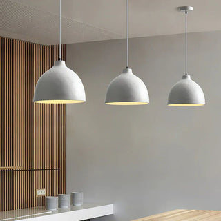 Bowl-shaped resin pendant hanging over kitchen counter