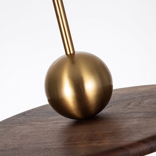 Saucer-shaped walnut pendant casting warm directional glow