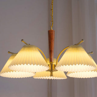 Elegant pleated brass chandelier front — dining room wood design