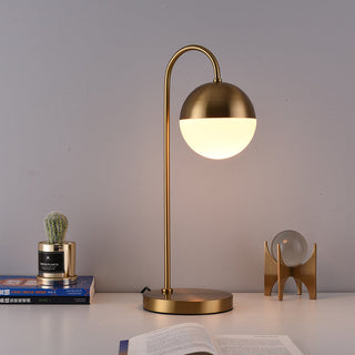 Brass arc sphere lamp side view — radiant orb warm light