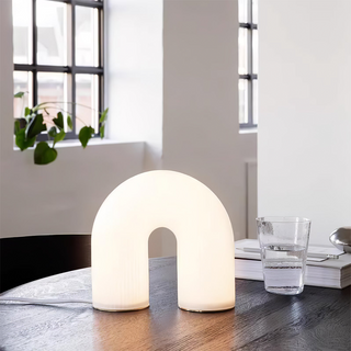 White metal arch lamp close-up — modern LED glass detail